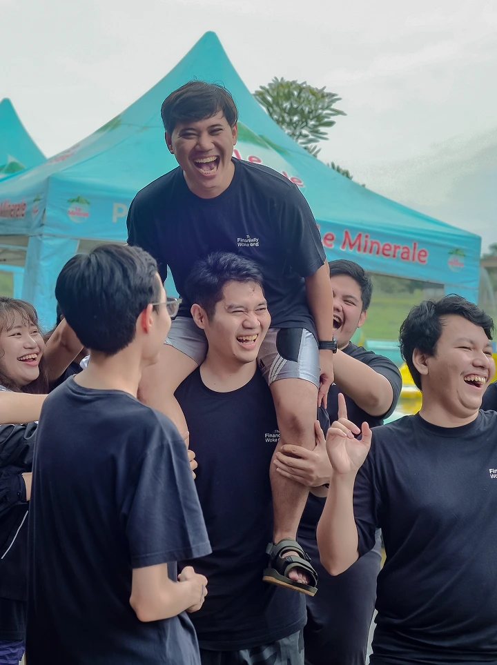Group of young people laughing and smiling outdoors.